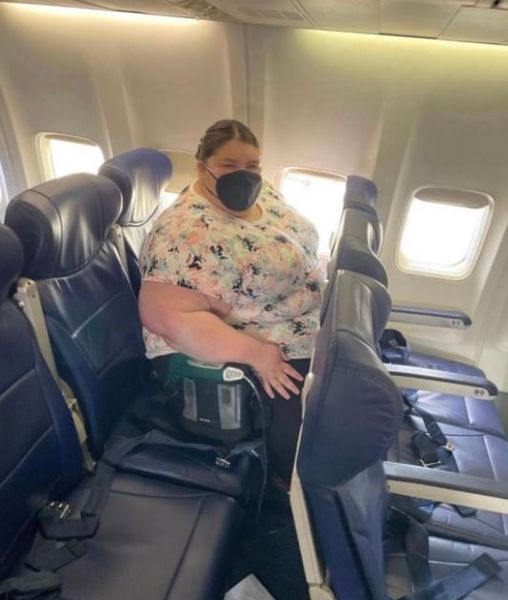 Woman tries to take her seat on a plane